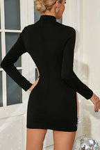 Back view of a black long-sleeve mini dress with cutout details.
