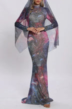 Full body shot of a woman in a cosmic-print gown with a flowing sheer veil.
