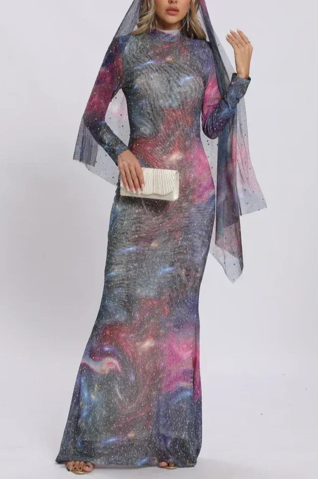 Woman holding a clutch while wearing a celestial-inspired maxi dress.