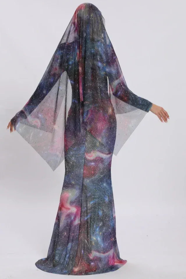 Back view of a woman in a shimmering galaxy dress with a dramatic sheer cape.