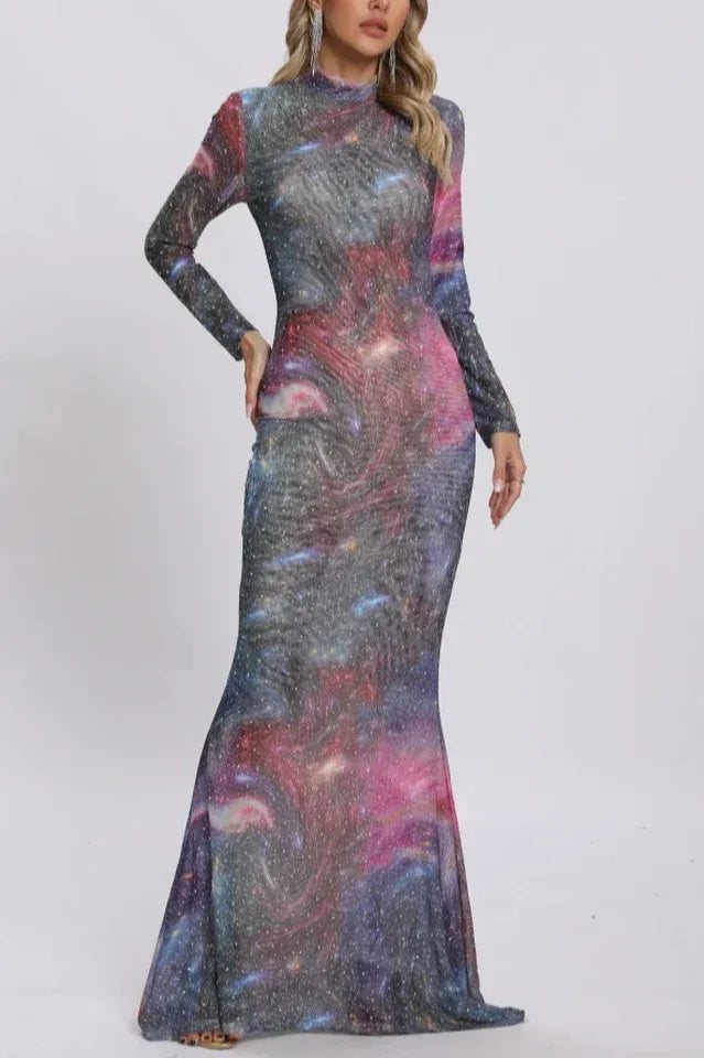 Front view of a woman showcasing a long-sleeved, high-neck galaxy print dress with glitter accents.