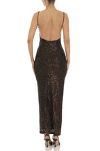 Woman wearing a floor-length dark sequined dress with spaghetti straps and a sweetheart neckline, back view