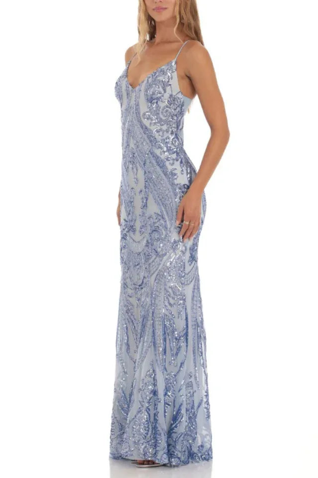 Three-quarter side view of a woman wearing a light blue sequined mermaid prom dress with spaghetti straps and a V-neckline.