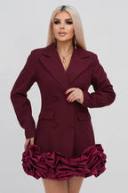Woman wearing a maroon double-breasted blazer dress with a ruffled hem