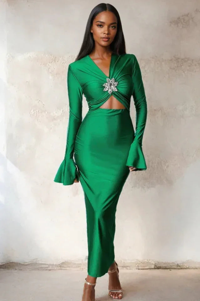 Woman wearing a long green satin dress with long flared sleeves and a cutout waist Main image