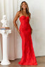 Woman in a red formal gown with a strapless neckline and elegant drape.
