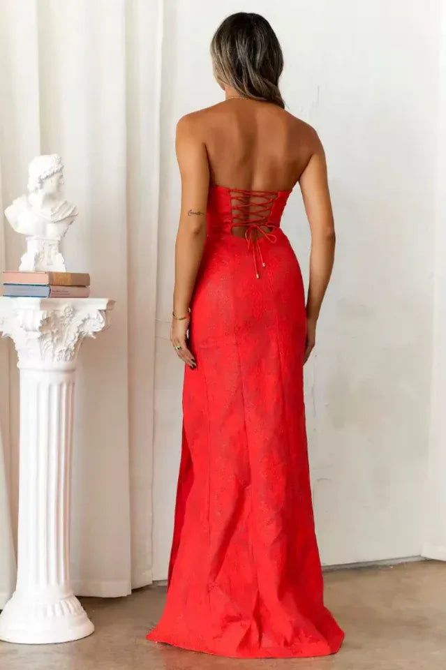 Back view of a red strapless gown with a lace-up detail at the back.