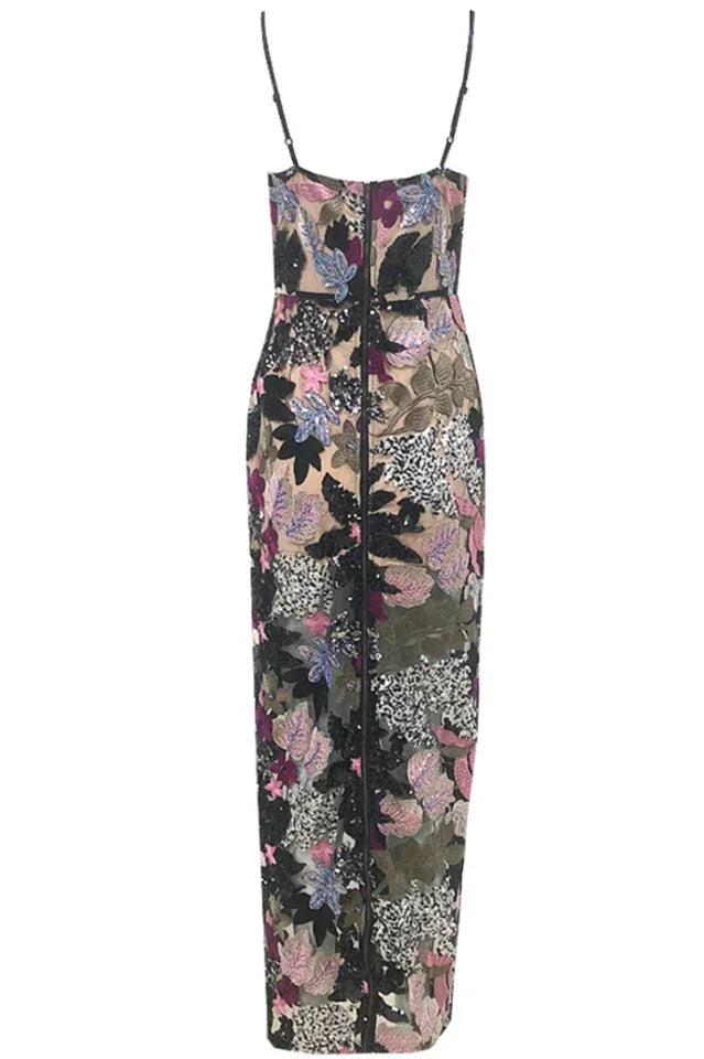Close-up front view of a floor-length sequined gown with floral appliqués and sheer fabric.
