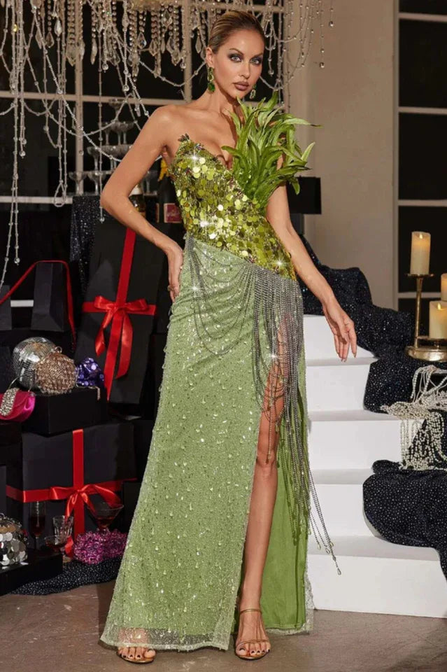 Side profile of a model showcasing a green sequined evening gown with intricate detailing.