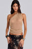 Woman wearing a gold one-shoulder metallic knit top and a black floral lace skirt, front view.