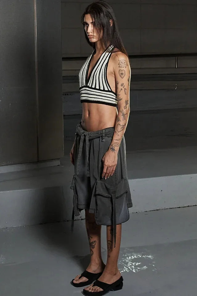 Side view of a model in a halter top and cargo shorts. Secondary image