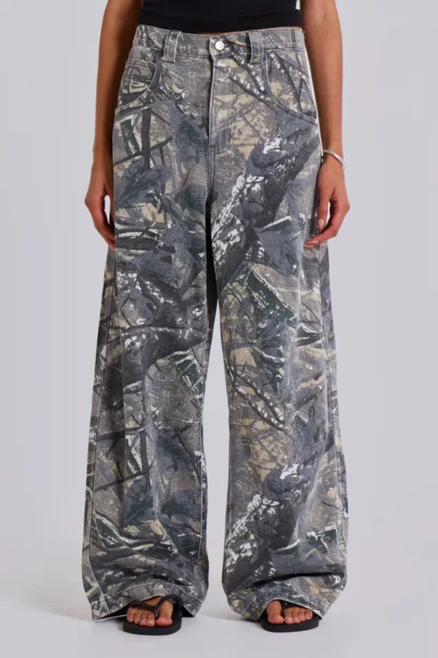 Close-up of the front of camouflage wide-leg jeans worn by a woman.