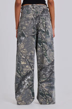 Close-up of the back of camouflage wide-leg jeans worn by a woman.