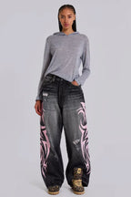 Model wearing wide leg jeans with tribal print and a grey hoodie