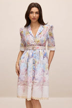 Front view of a woman in a floral print midi dress with a collared V-neck and button-down front
