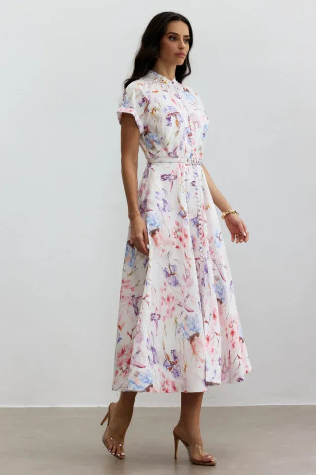 Full body shot of a woman in a floral print midi dress, showcasing the A-line silhouette and midi length.