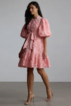 Close-up of the detailing on a pink floral applique dress
