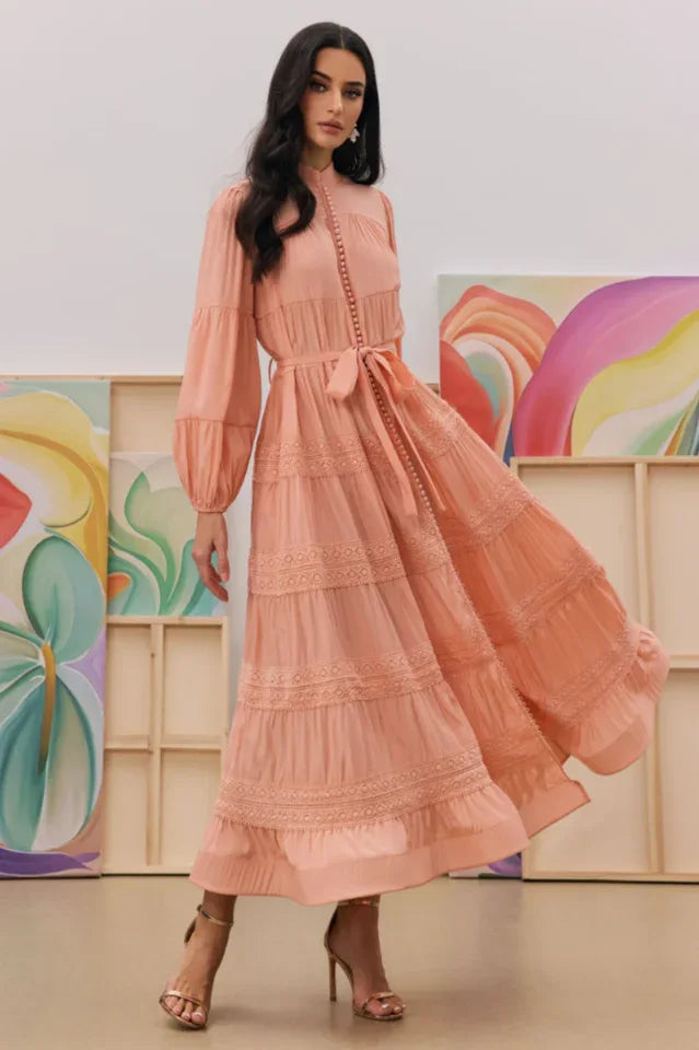 Woman twirling in a peach tiered midi dress with lace trim Secondary image