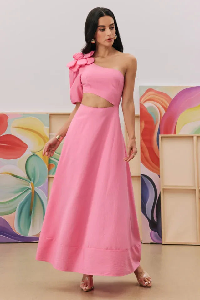 Full-length view of a woman in a pink one-shoulder dress with a cut-out waist and floral detail. Secondary image