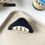 Dimensions and weight of a black and white triangular hair claw
