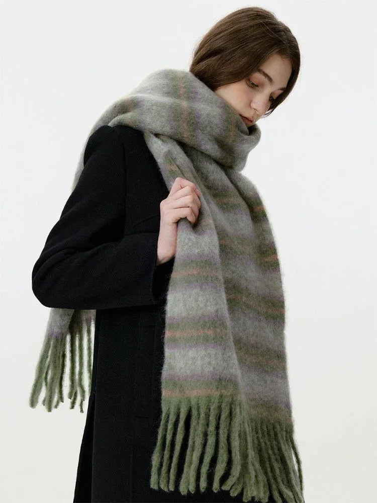 Close-up of a woman wearing a fuzzy, striped scarf with fringe detail.