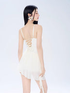 Back view of the white dress showcasing the lace-up detail and sheer skirt