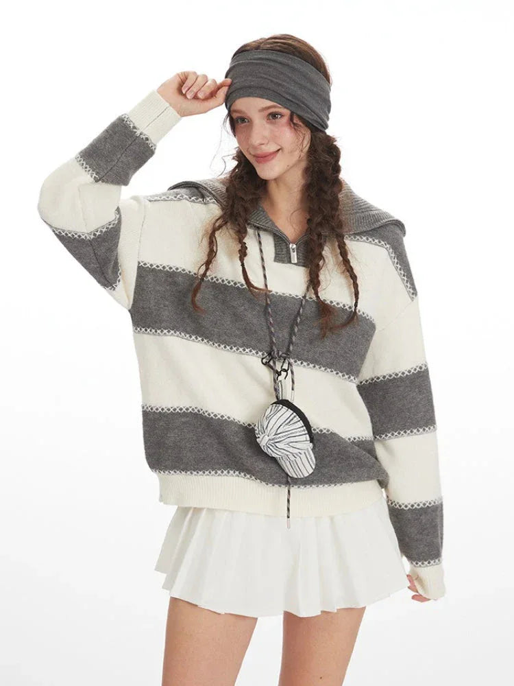 Close-up of a model wearing a striped knit sweater and smiling