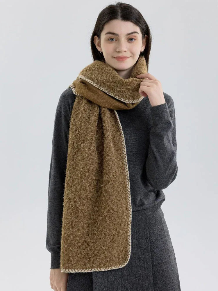 Woman wearing a brown fuzzy knit scarf and dark grey sweater