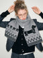 Model wearing a gray knit scarf with a dachshund pattern and zigzag design.