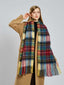 Woman adjusting her plaid scarf