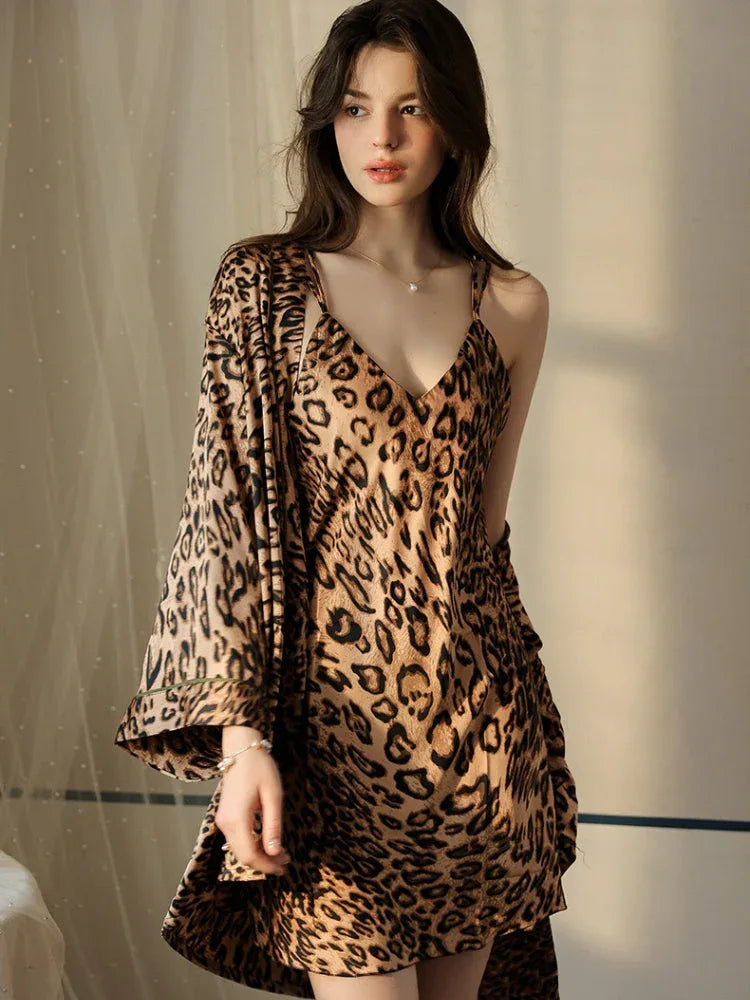 Woman in a leopard print satin cami slip dress and robe.