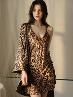 Woman in a leopard print satin cami slip dress and robe.