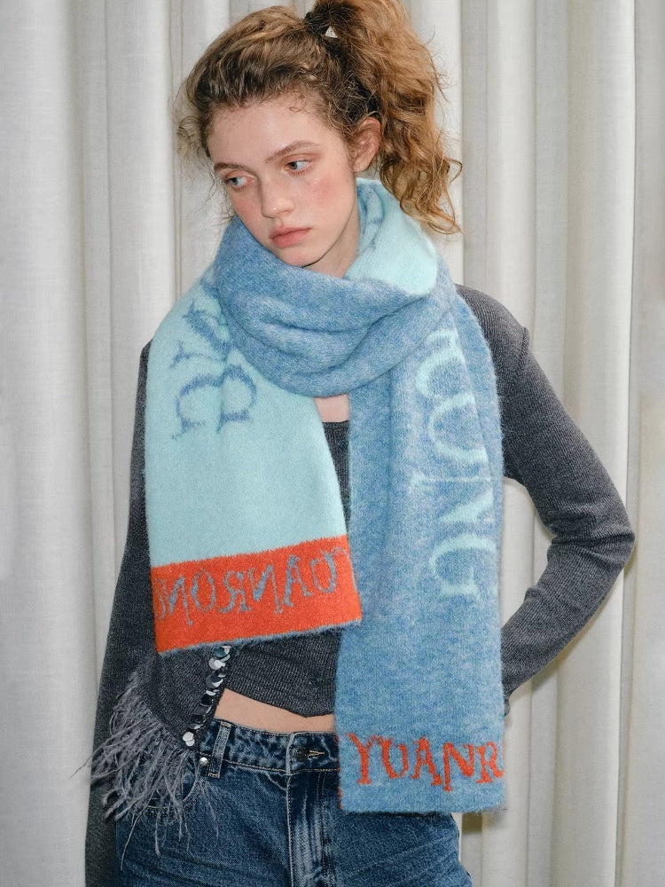 Model wearing a blue and light blue scarf with orange trim and text. Main image