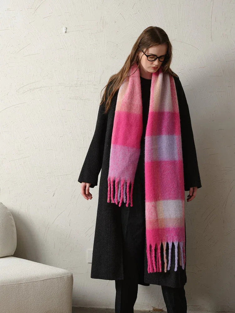 Close-up of a woman's outfit featuring a statement plaid scarf.