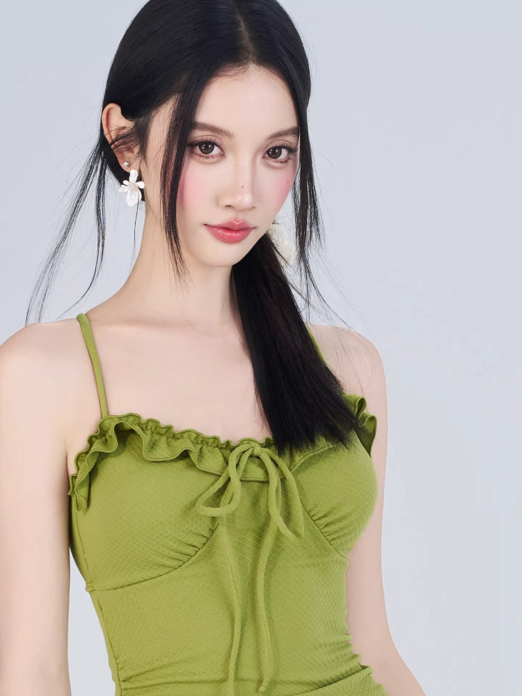 Close-up of the green ruffled dress neckline with tie detail