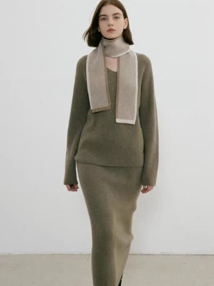 Close-up of a woman wearing a taupe sweater and scarf