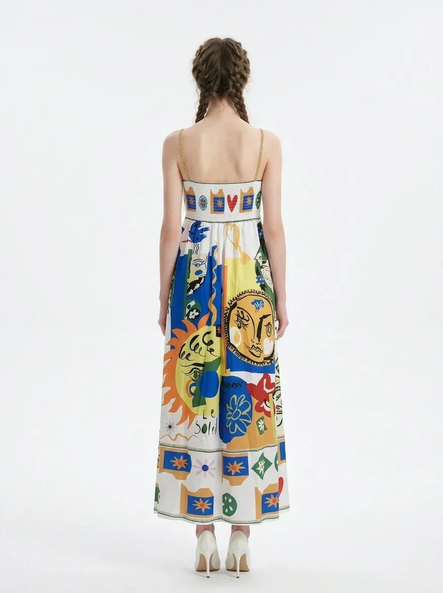 Back view of a woman wearing a white maxi dress with a colorful abstract print and spaghetti straps, standing against a white background.