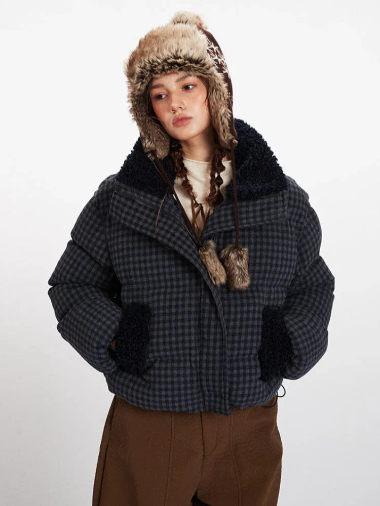 Front view of a woman in a plaid puffer jacket with faux fur details.