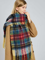 Woman smiling while wearing a plaid scarf