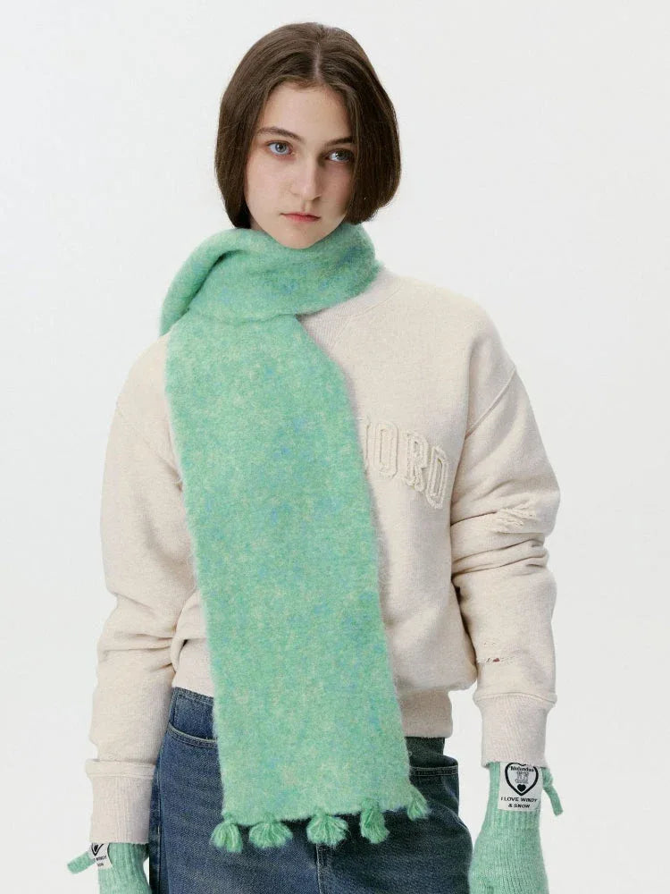 Model wearing a mint green fuzzy scarf with tassels Main image