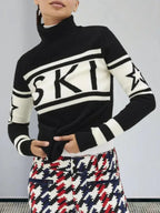 Close-up of a woman wearing a black and white turtleneck ski sweater with "SKI" graphic and stars.