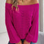Woman wearing a fuchsia off-the-shoulder knit sweater with an open-knit pattern and long sleeves.