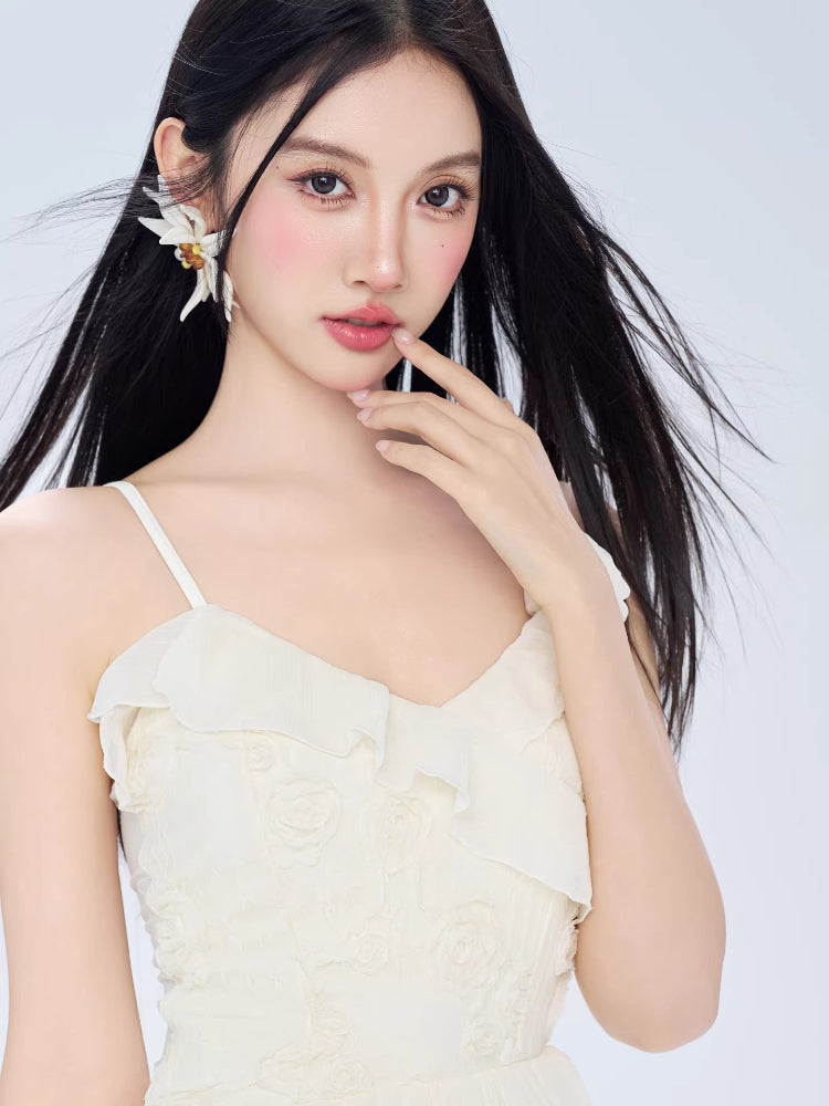 Close-up of the model's face and the white dress neckline with floral accents