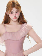 Close-up of the ruffled neckline of a pink swimsuit.
