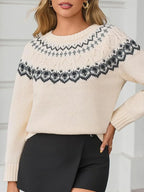 Woman wearing a cream-colored knit sweater with a Fair Isle pattern around the yoke and black trousers.