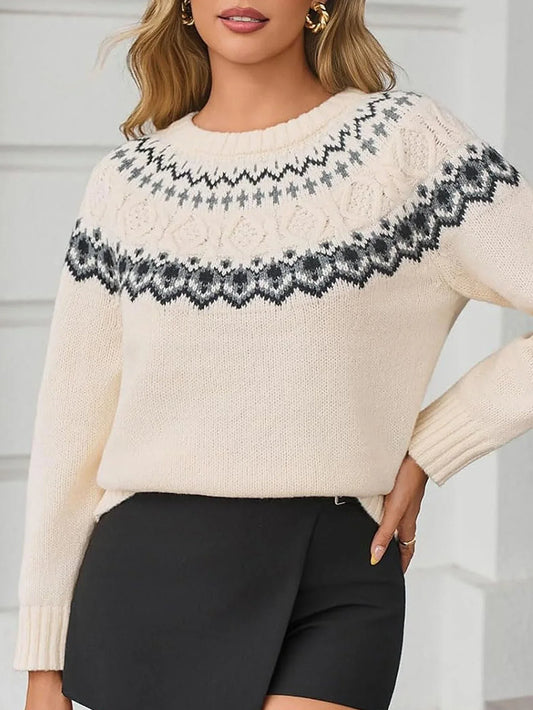 Woman wearing a cream-colored knit sweater with a Fair Isle pattern around the yoke and black trousers.