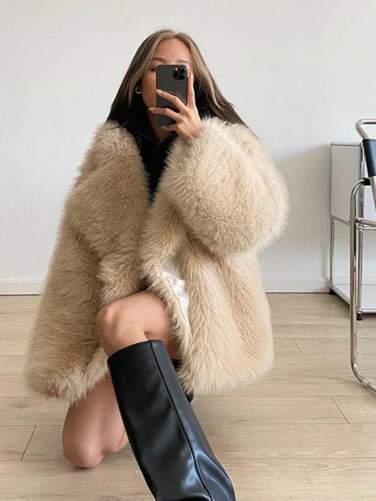 woman wearing a beige faux fur coat and black boots