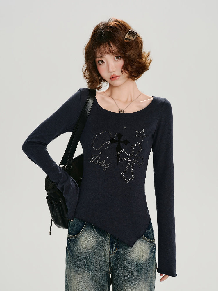 Close-up of the graphic print on the dark blue long-sleeve top, featuring crosses and stars.