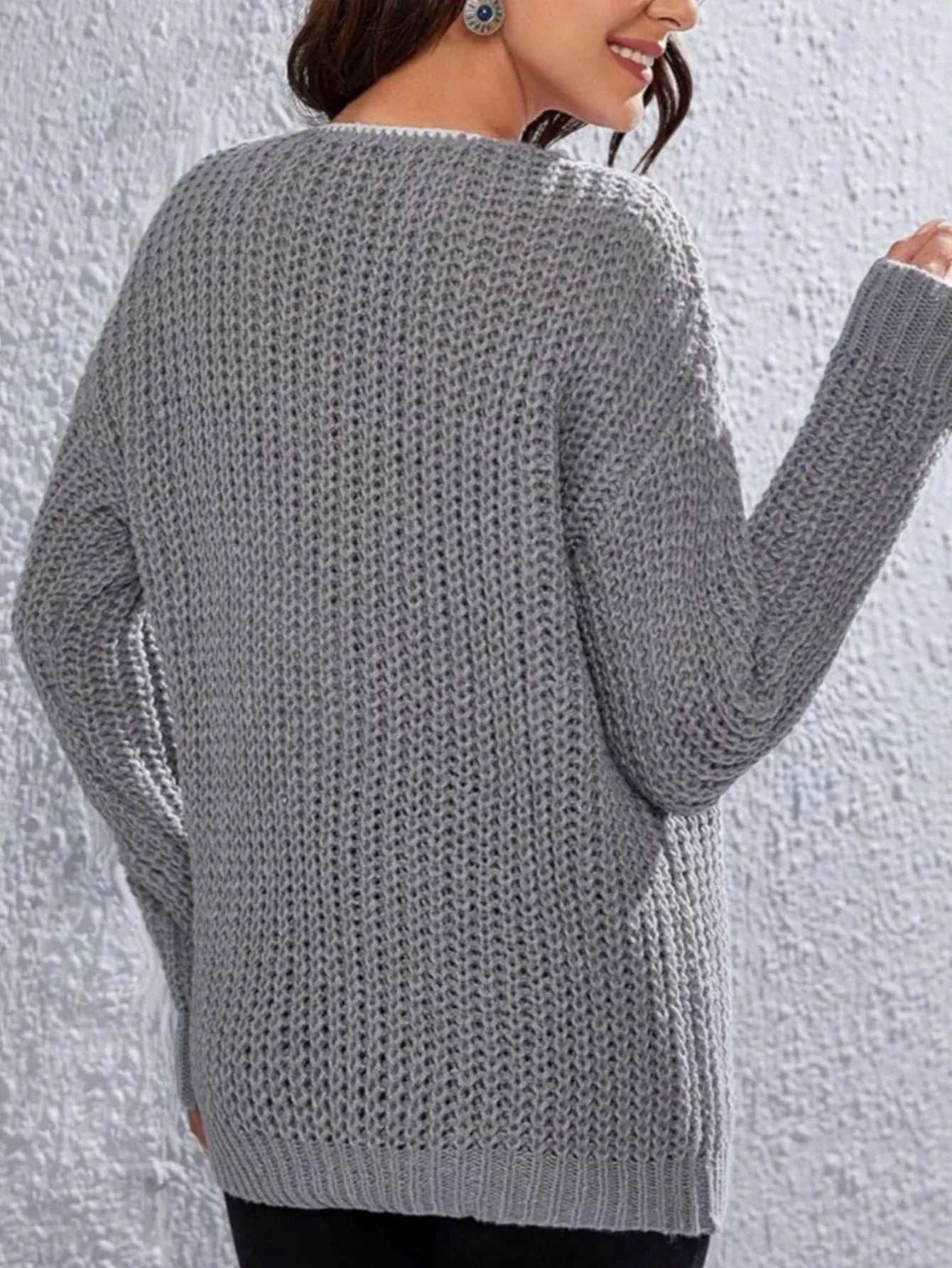 Back view of a woman in a grey knit sweater