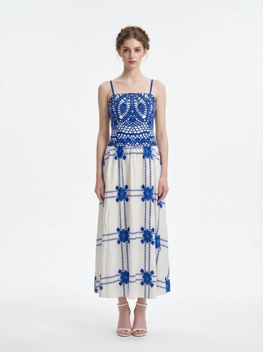 Woman wearing a blue and white crocheted and embroidered maxi dress, front view.